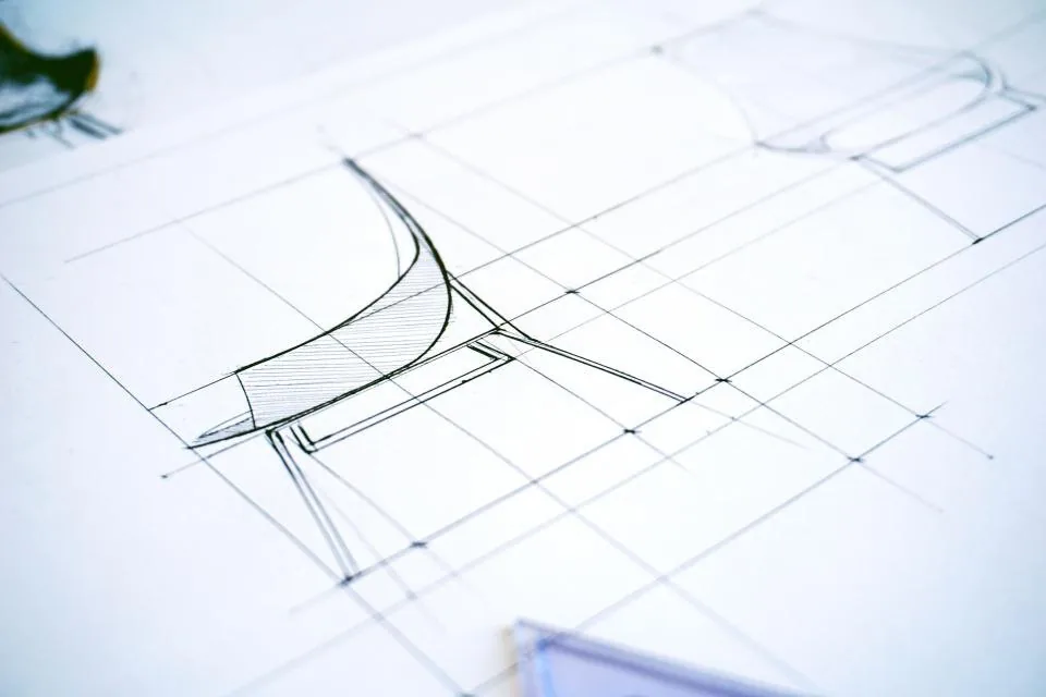printed documents, a clipboard and a pen spread across a desk