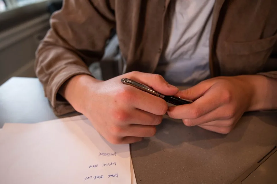 printed documents, a clipboard and a pen spread across a desk