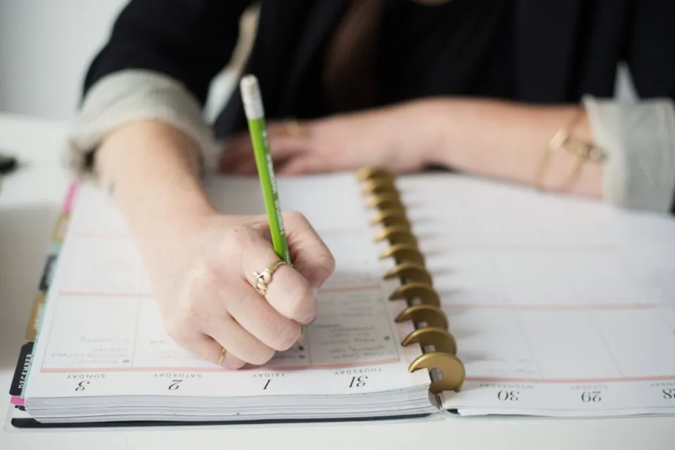 printed documents, a clipboard and a pen spread across a desk