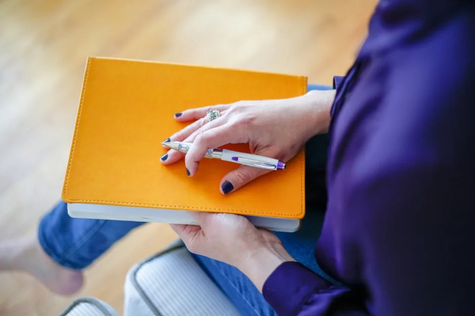 printed documents, a clipboard and a pen spread across a desk