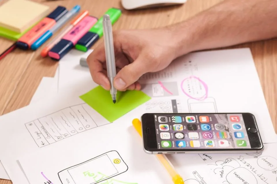 printed documents, a clipboard and a pen spread across a desk