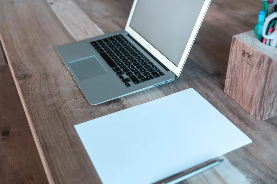 printed documents, a clipboard and a pen spread across a desk