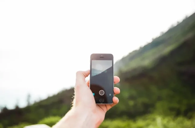 a hand holding a smartphone with the screen facing the camera