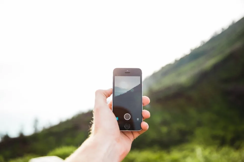 a hand holding a smartphone with the screen facing the camera