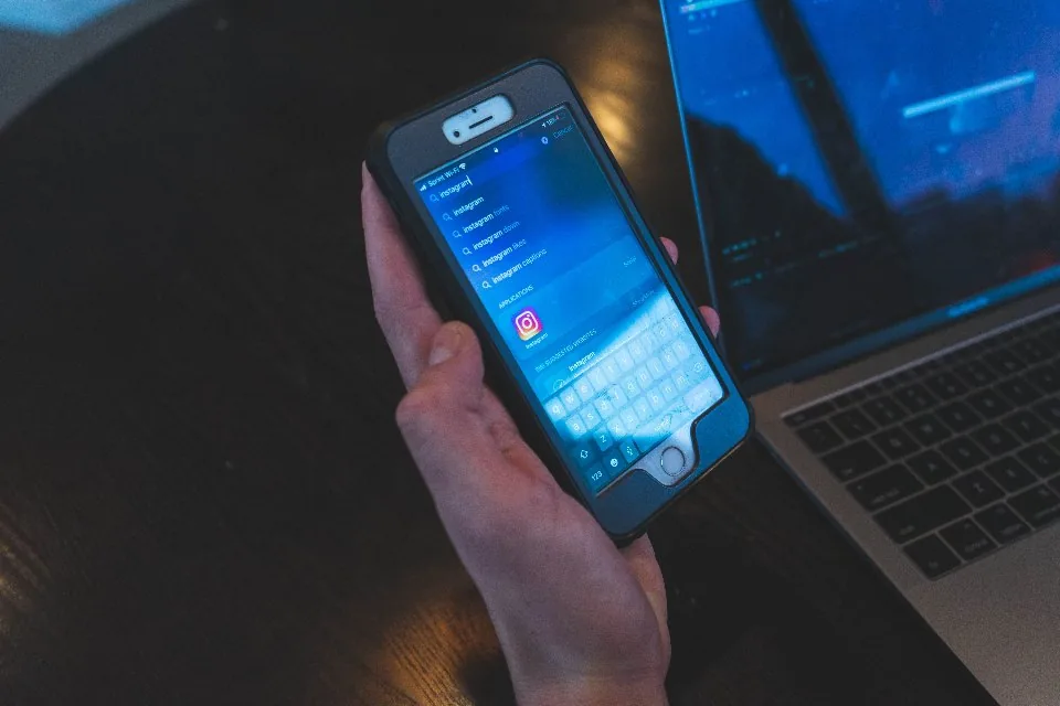 a hand holding a smartphone with the screen facing the camera