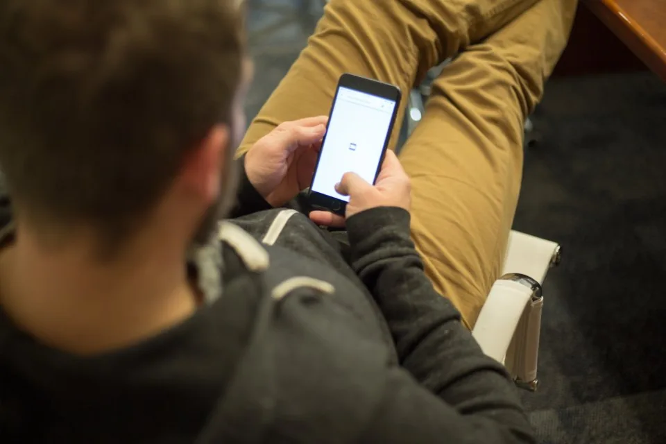 a hand holding a smartphone with the screen facing the camera