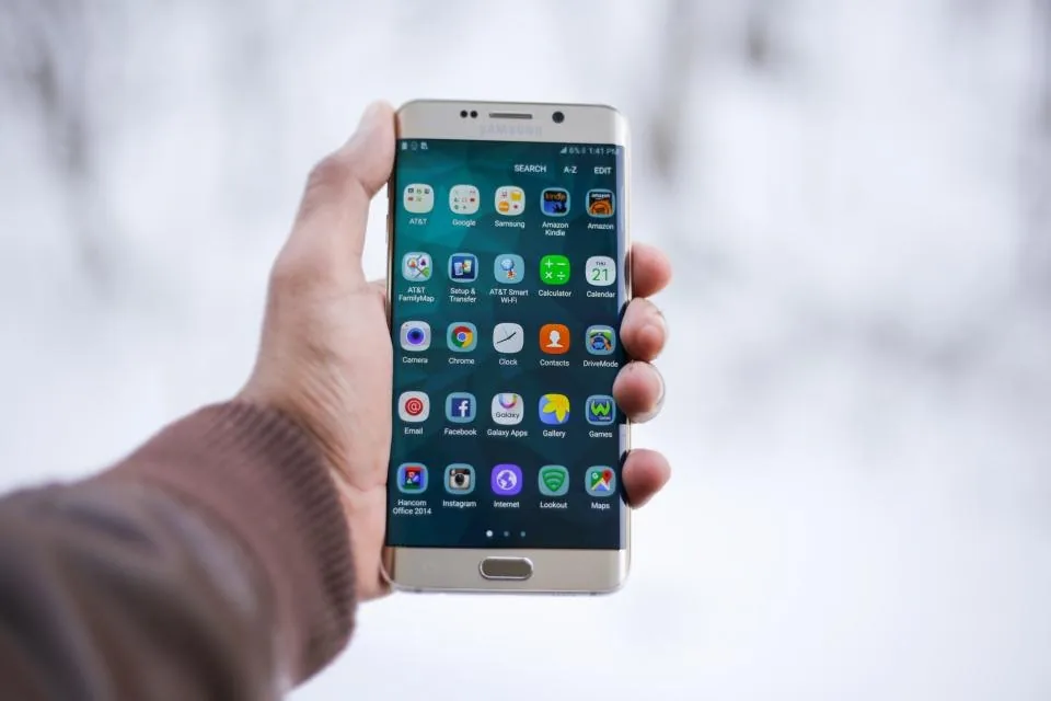 a hand holding a smartphone with the screen facing the camera