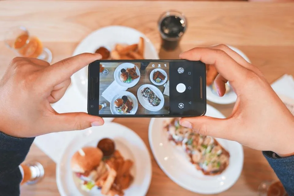 a hand holding a smartphone with the screen facing the camera