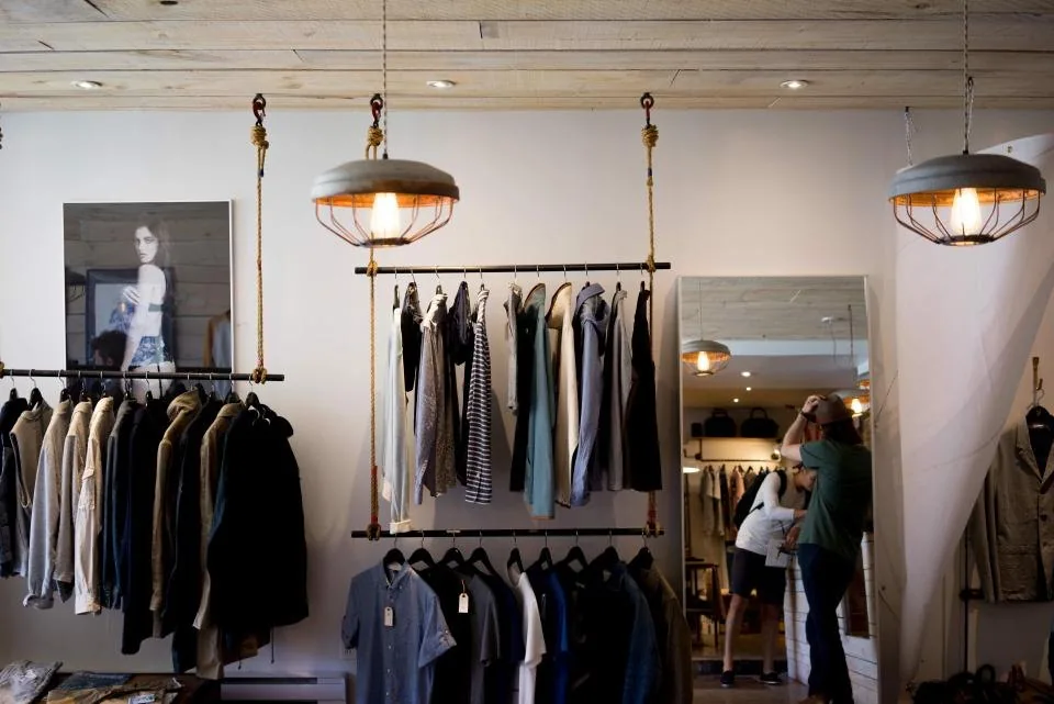 the interior of a shop with racks of stock and a counter