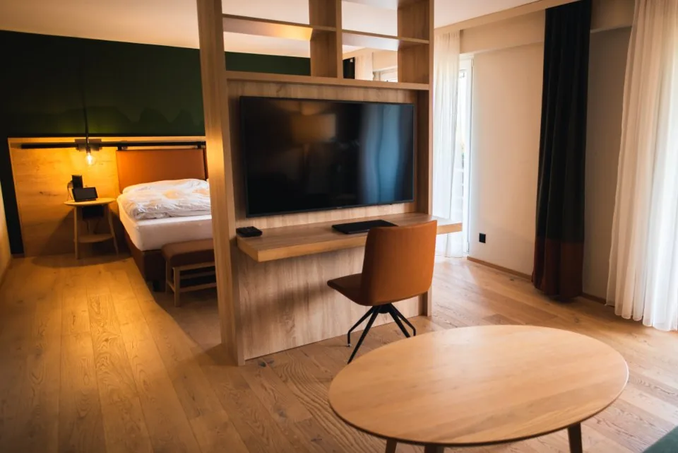 a desk by a window with a laptop open in daylight