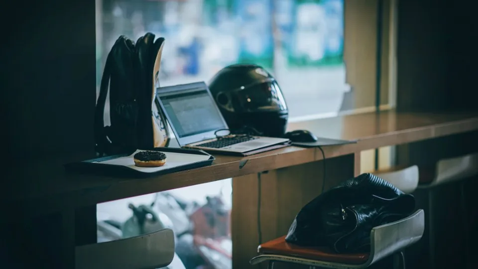 a desk by a window with a laptop open in daylight