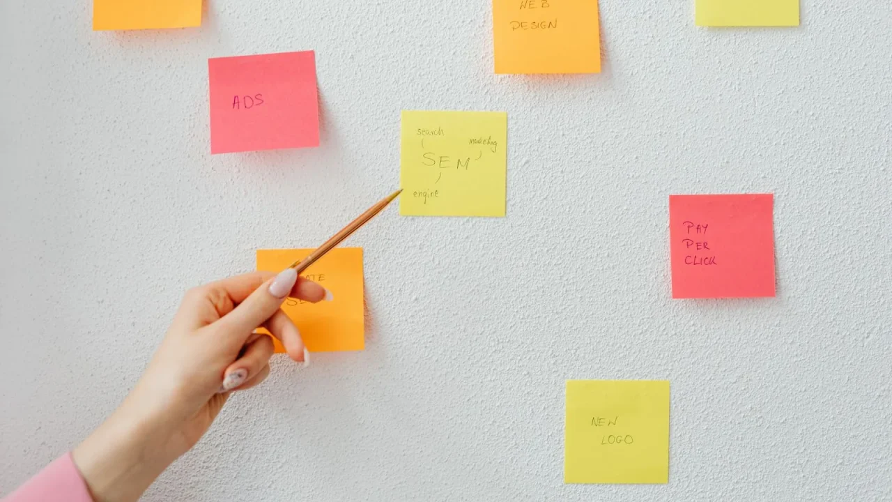 Planning notes arranged on a wall during a requirements discussion.
