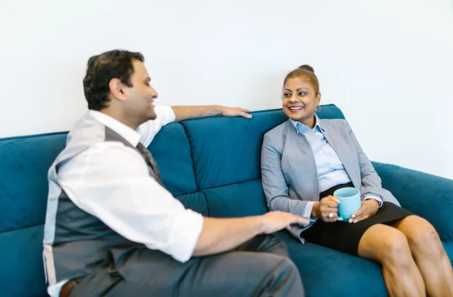 Two colleagues talking over a coffee break in the office.
