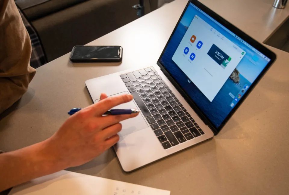 a laptop open beside a tablet on a desk