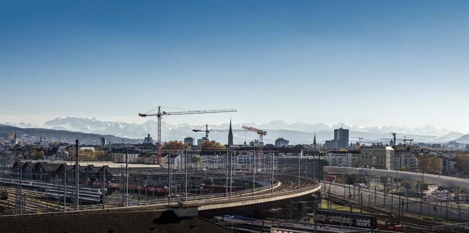 a building site with cranes and a partly finished structure