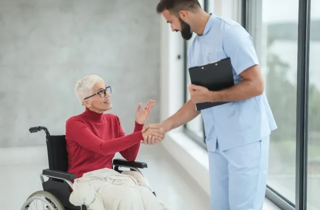 a clinician consulting with a patient in a bright treatment room