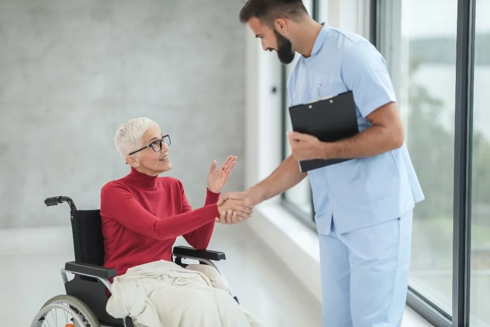 a clinician consulting with a patient in a bright treatment room