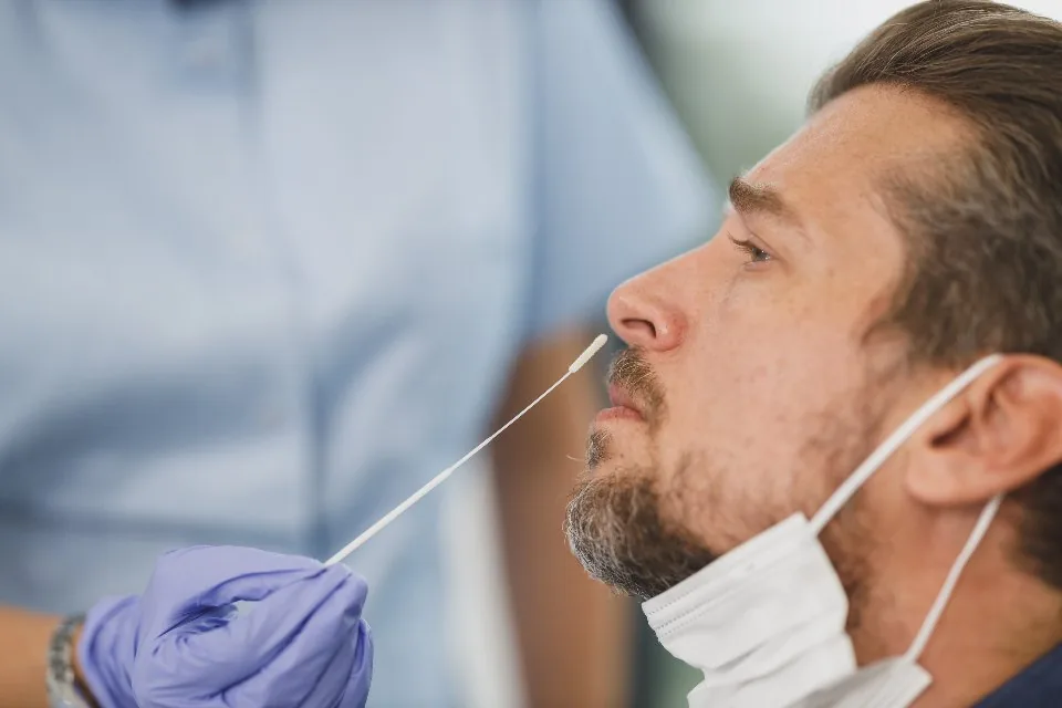 a clinician consulting with a patient in a bright treatment room