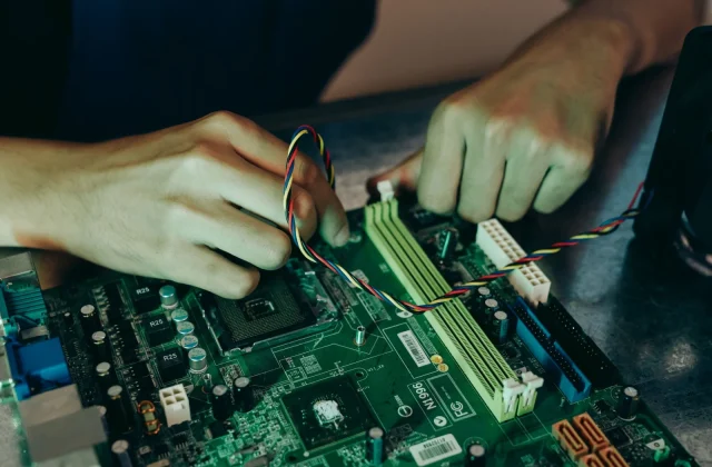 An engineer working at a multi-screen workstation reviewing data and machine learning output.
