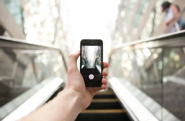 a hand holding a smartphone with the screen facing the camera