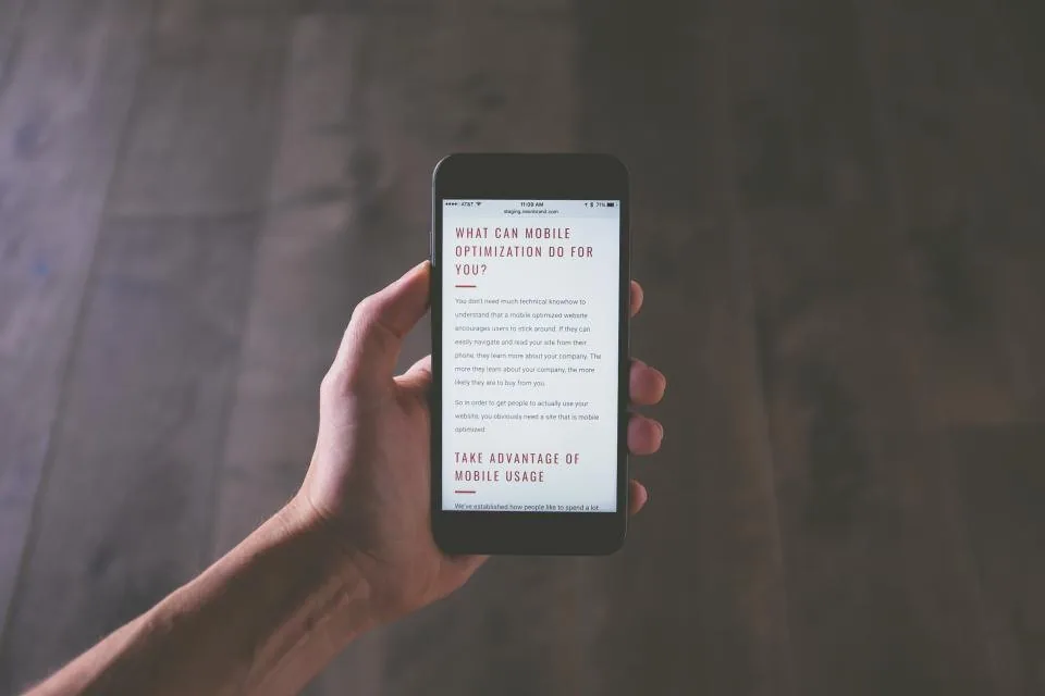 a hand holding a smartphone with the screen facing the camera