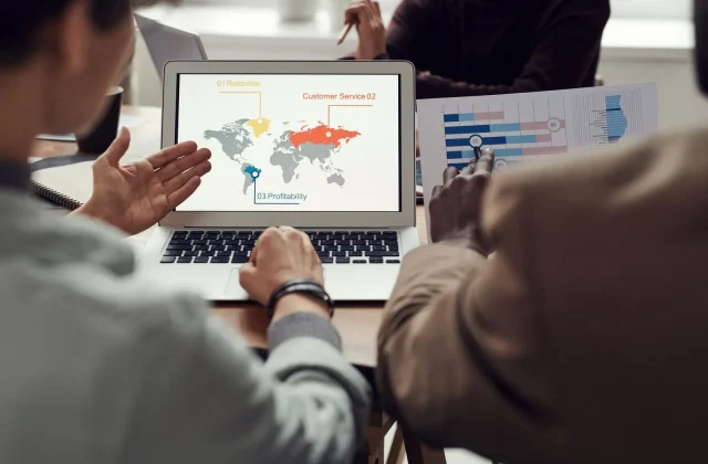A team reviewing a global data dashboard together.