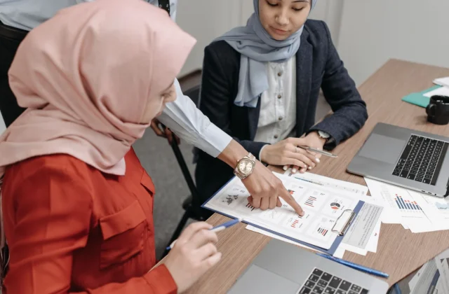 A project team reviewing a client deliverable together in a meeting room.