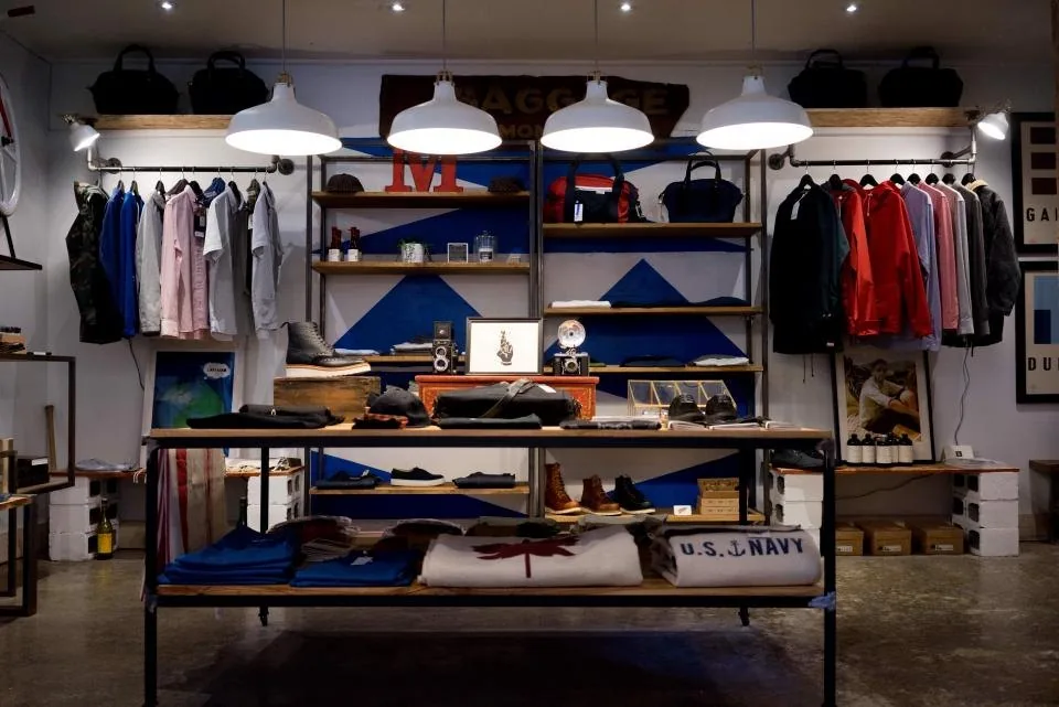 the interior of a shop with racks of stock and a counter