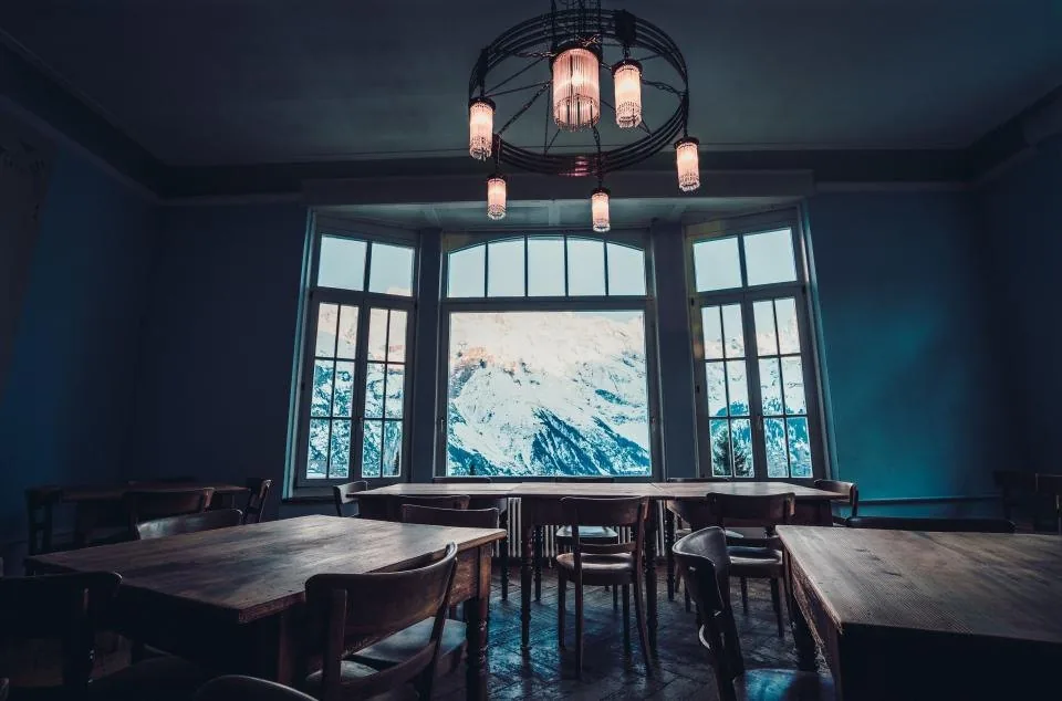 a desk by a window with a laptop open in daylight