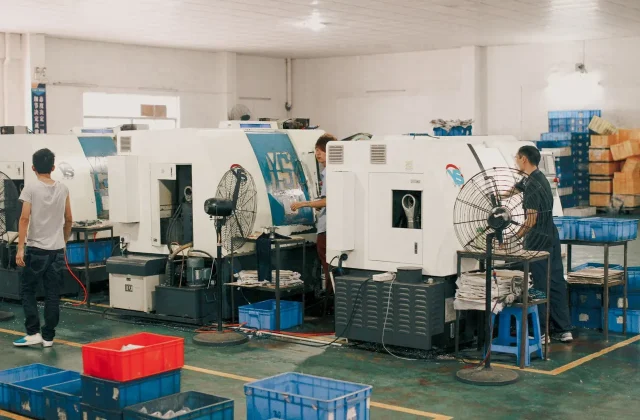 Factory workers on the workshop floor during a production run.